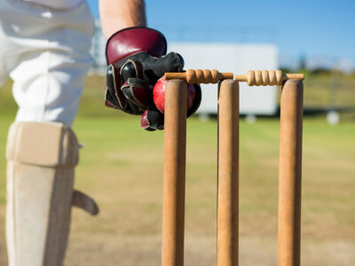 Close up of wicket keeper standing by stumps during match 