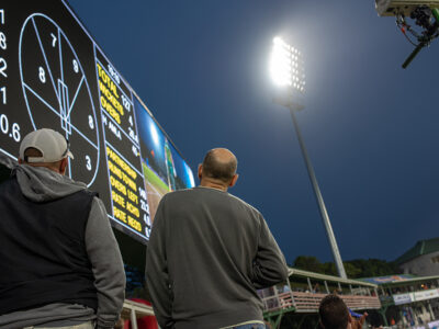 Fans looking at cricket scoreboard 